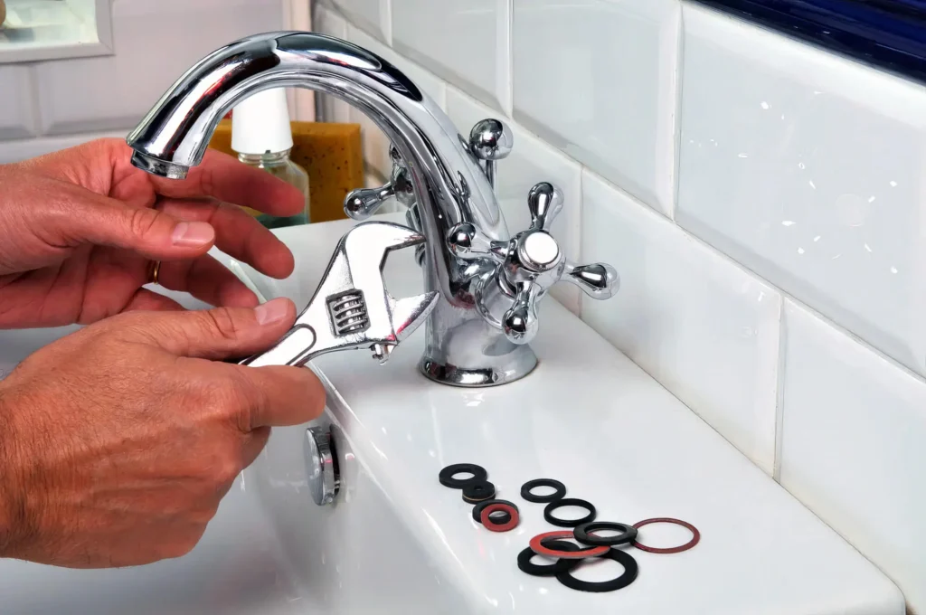 Plumber performing maintenance on a bathroom faucet in Rialto