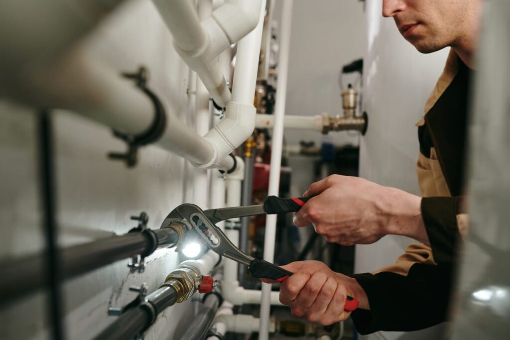 Plumbers maintaining commercial plumbing pipes in Rialto