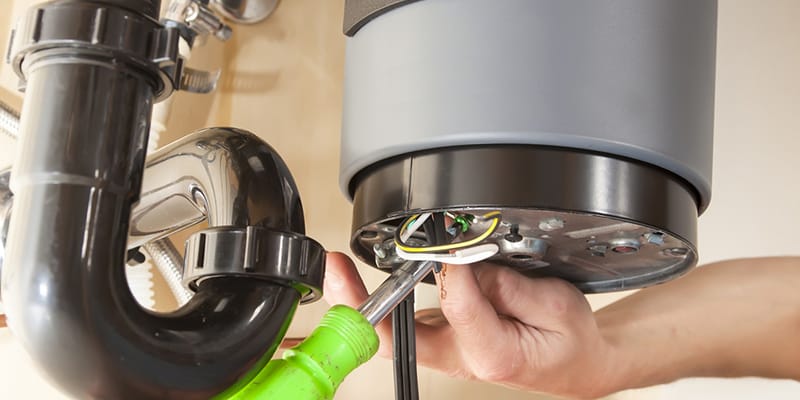 Technician repairing the heating element of a water heater in Rialto