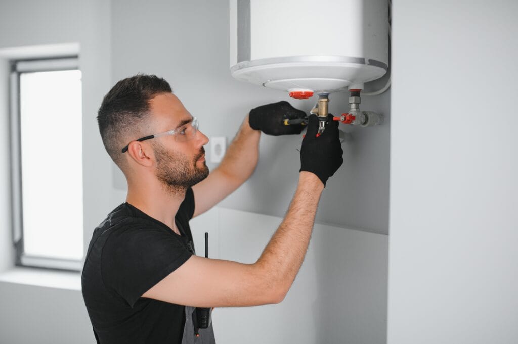 Technician performing water heater maintenance in Rialto