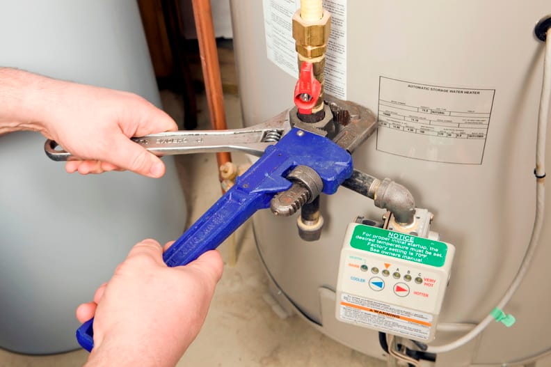 Plumber repairing a water heater valve in Rialto